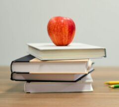 Apple on top of Books